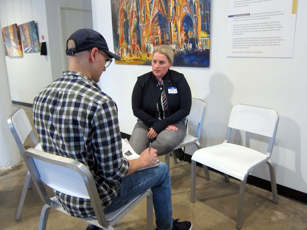 A volunteer attorney speaks with an artist at a VLAA copyright clinic
