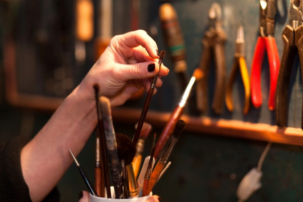 an artist selects a paintbrush